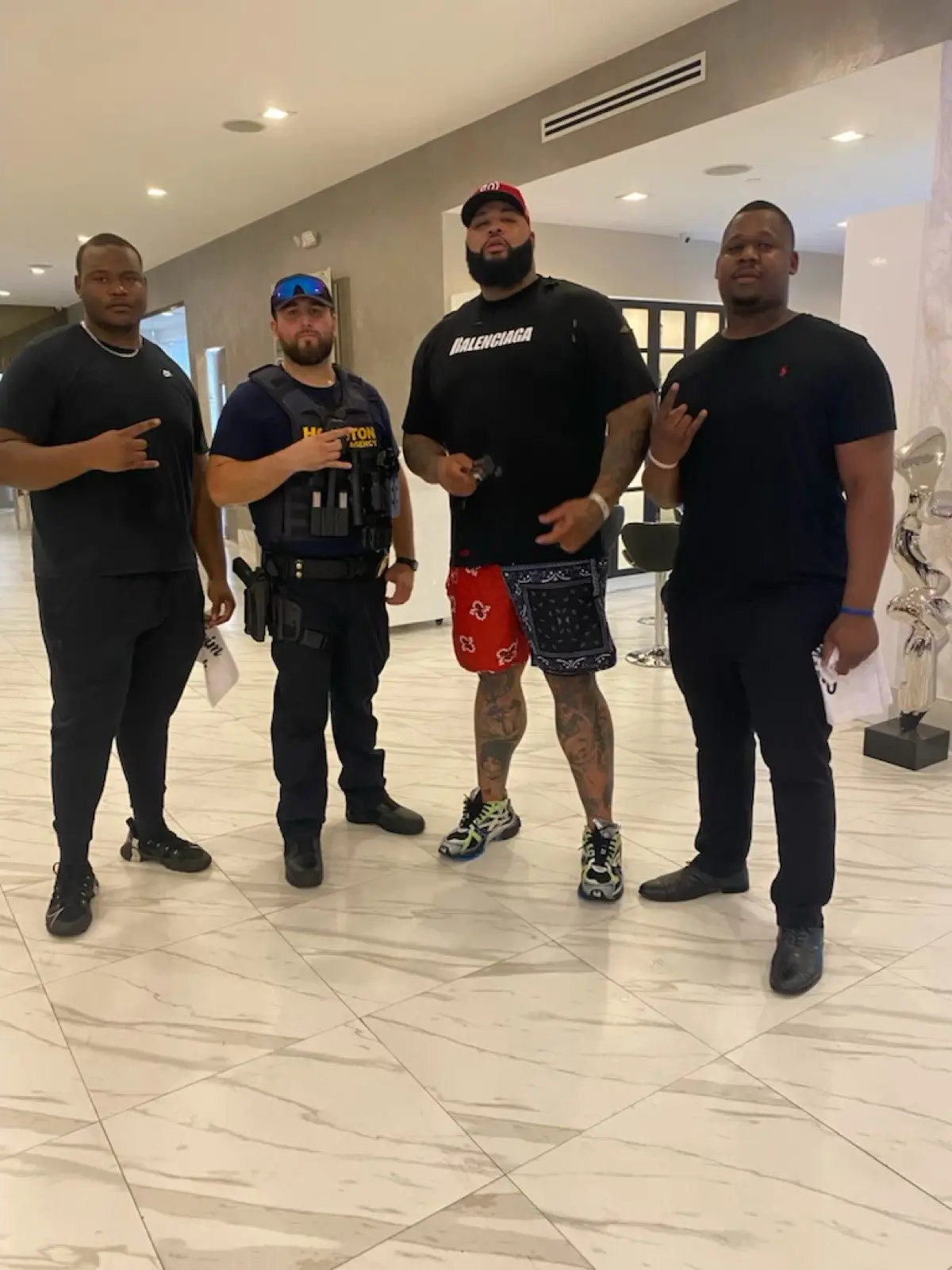 Houston Tactical Agency officer with a principal in a Houston lobby